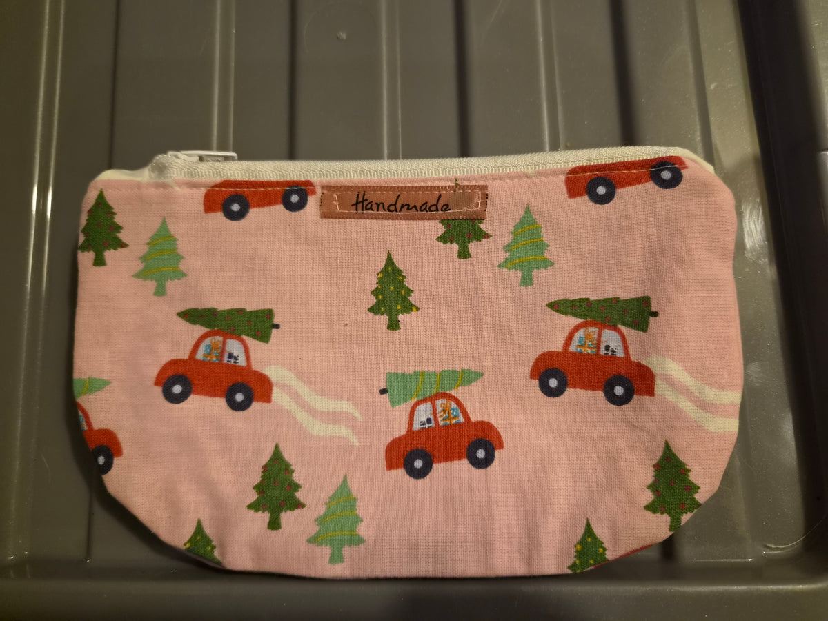 Handmade pink makeup bag with red cars carrying Christmas trees pattern