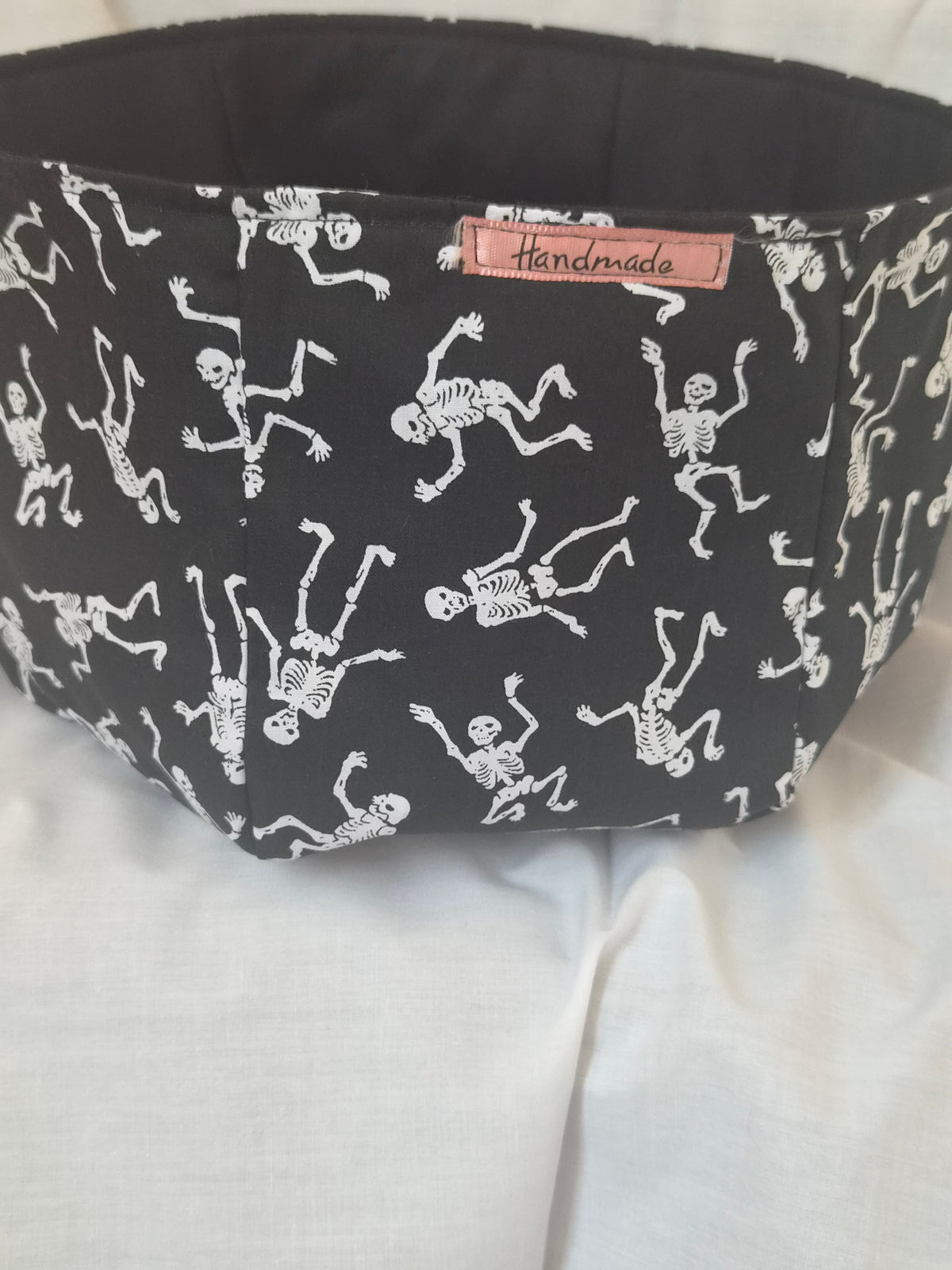 Handmade black fabric basket with white dancing skeletons pattern